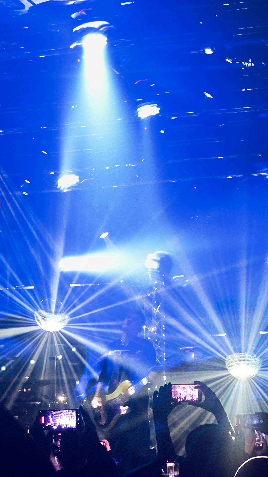 Concert crowd with colorful stage lights in the background