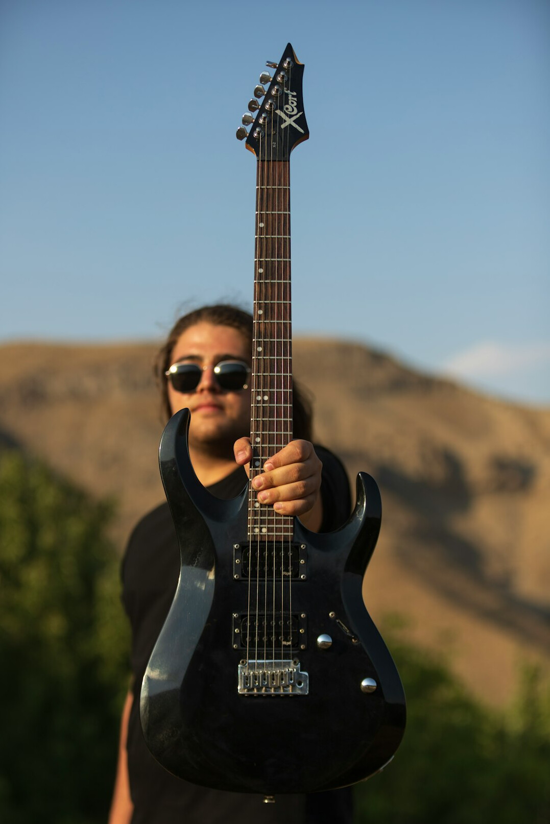 musician playing guitar outdoors